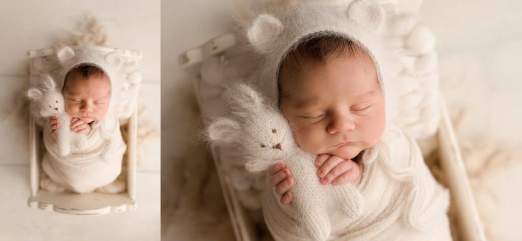  Newborn Baby laying in a cream cradle cuddling a cream stuffed rabbit while being photographed by a Boca Raton Photographer