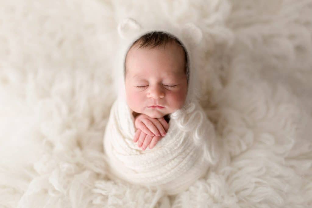 A Jupiter Newborn Photographer captures a tiny baby sleeping. 