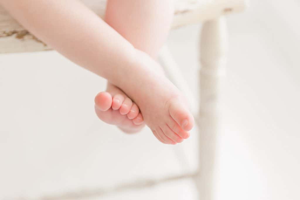 A baby's feet are crossed. 