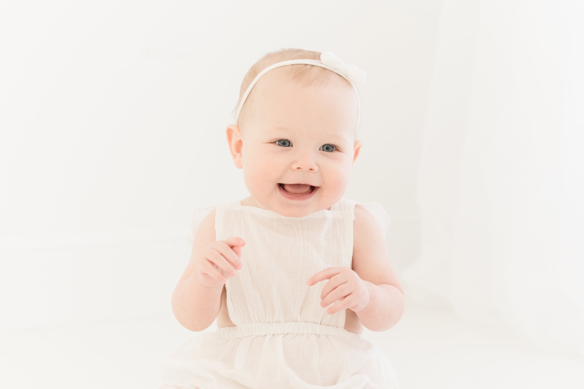 Baby girl being photographed in photography studio.