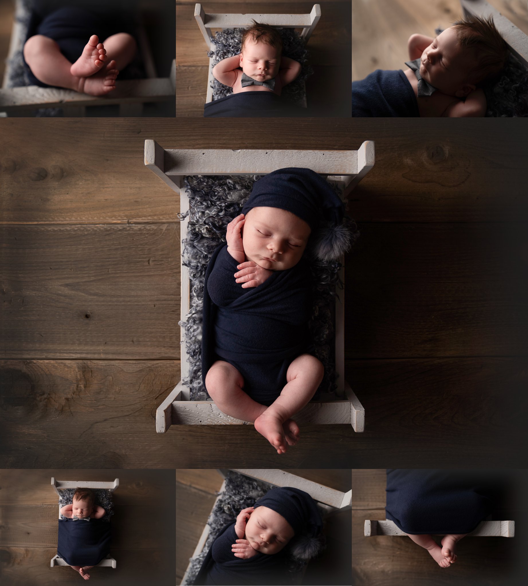 Photo of newborn baby boy being photographed in Jupiter Florida photography studio wrapped in a navy swaddle lying on a grey bed on a darkwood floor