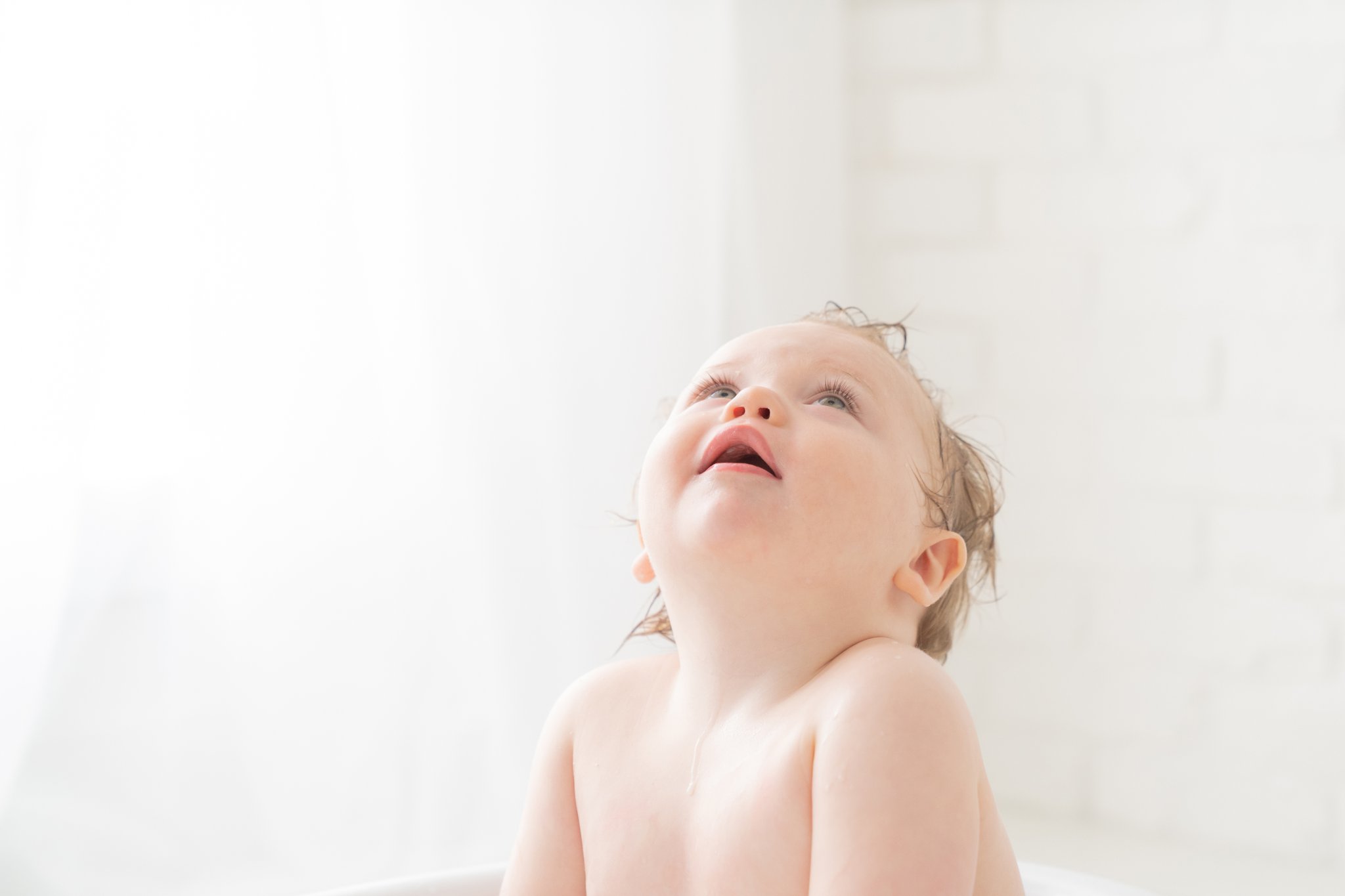 One year old baby in antique tub wash basin in south florida baby photography studio. 