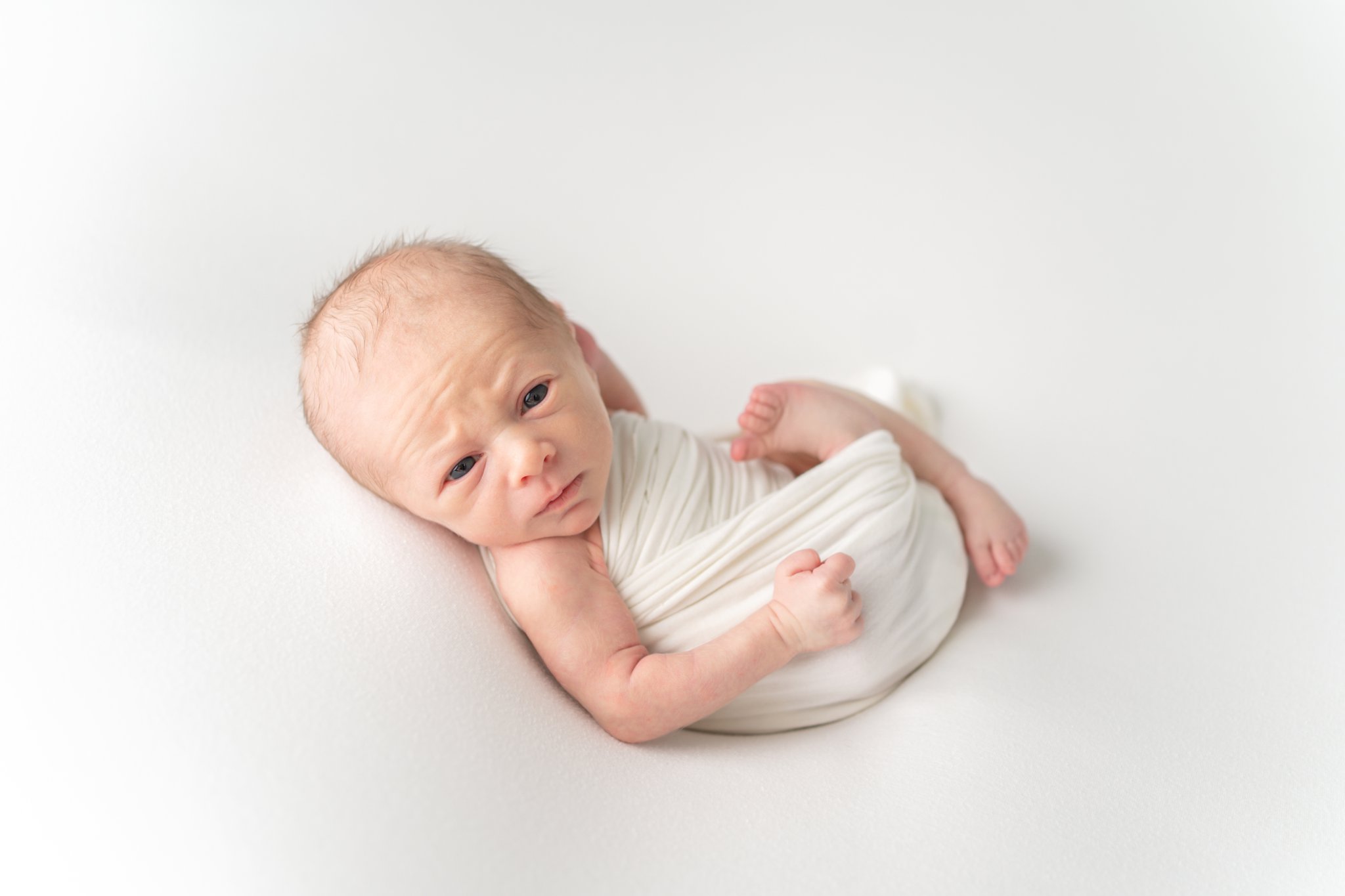Newborn baby being photographed in south florida photo studio.