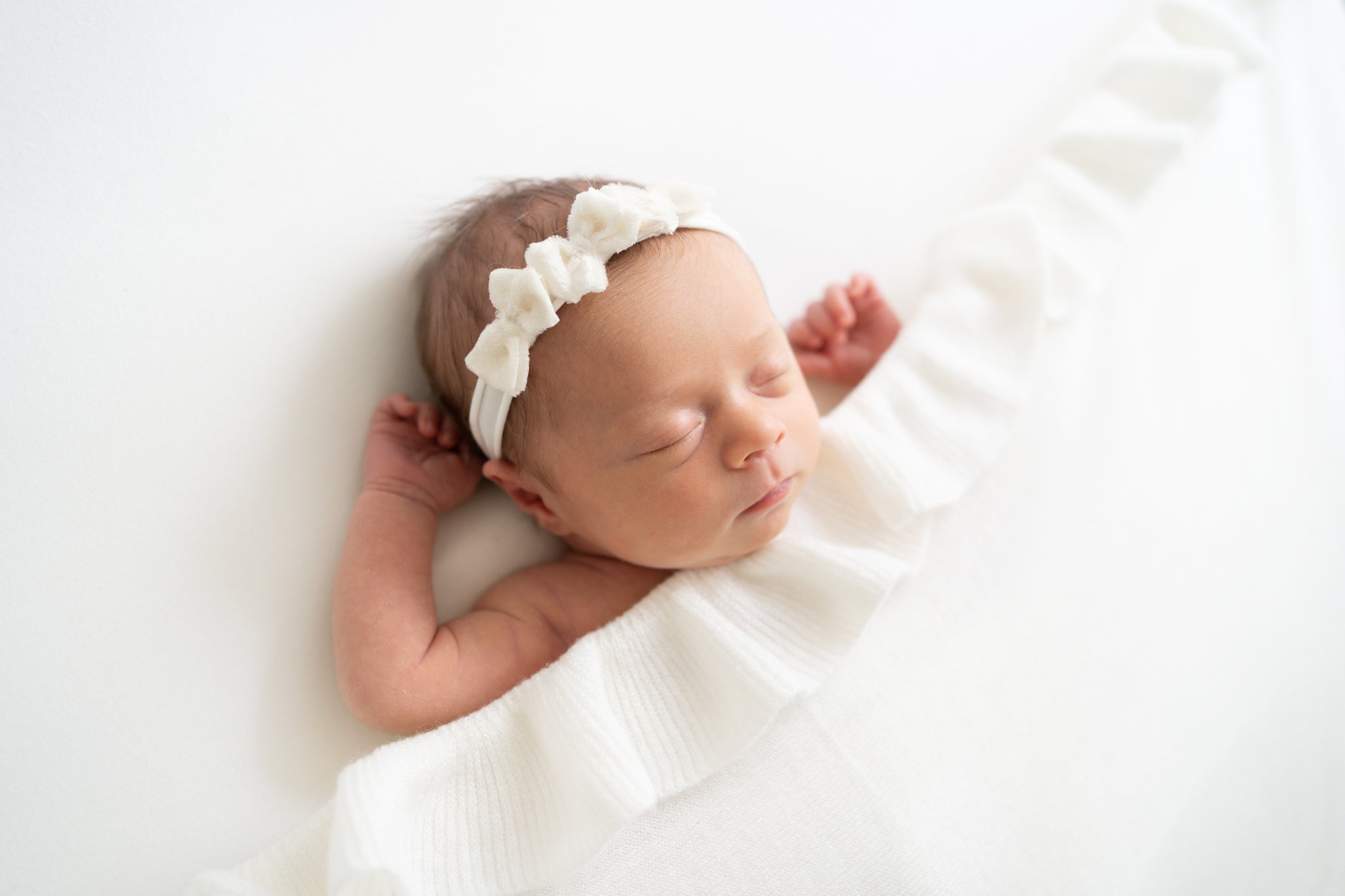 Family Newborn Session baby tucked in with a ruffle trimmed blanket