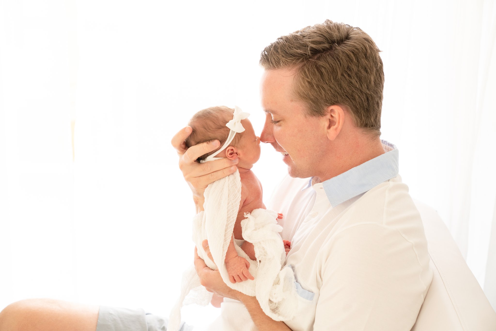 Newborn baby and dad being photographed in jupiter photography studio