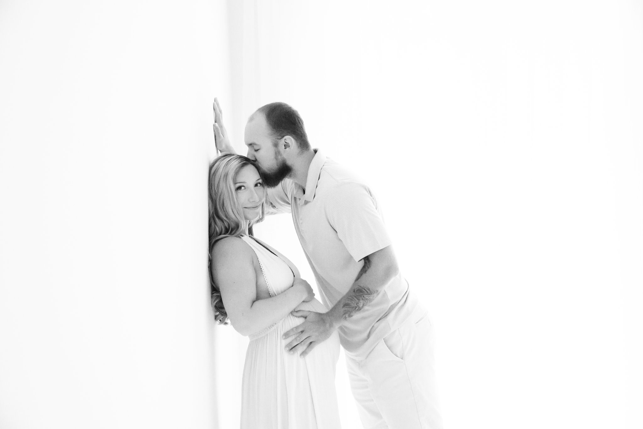 Couple being photographed wearing studio maxi dress in Jupiter Florida photography studio