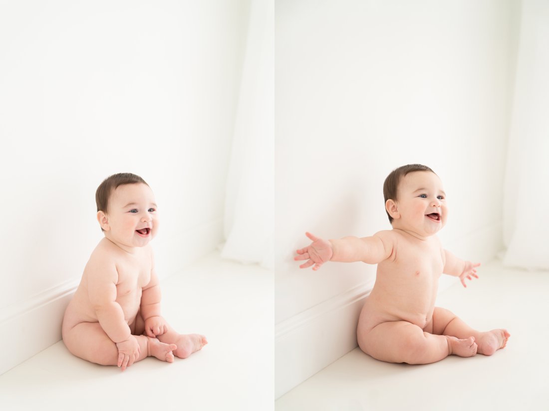 Baby boy sitting against a large white wall in a photography studio in Jupiter Florida