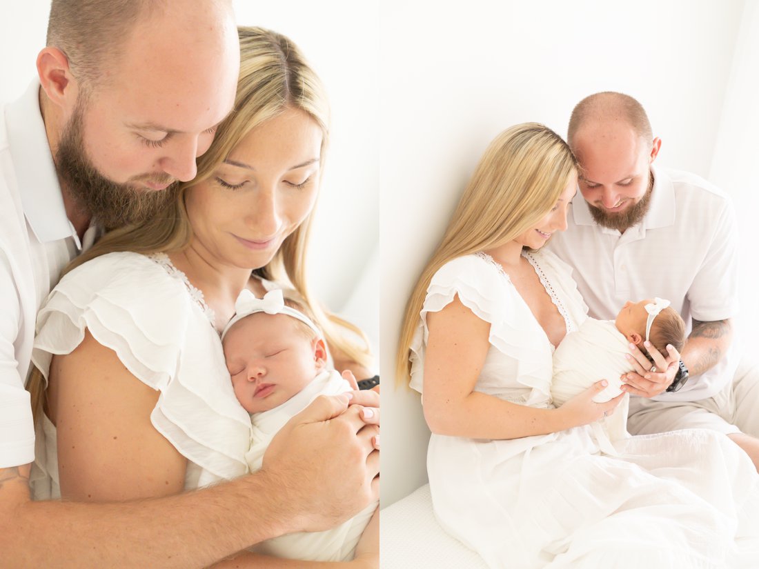 Newborn baby being held by her mom and dad