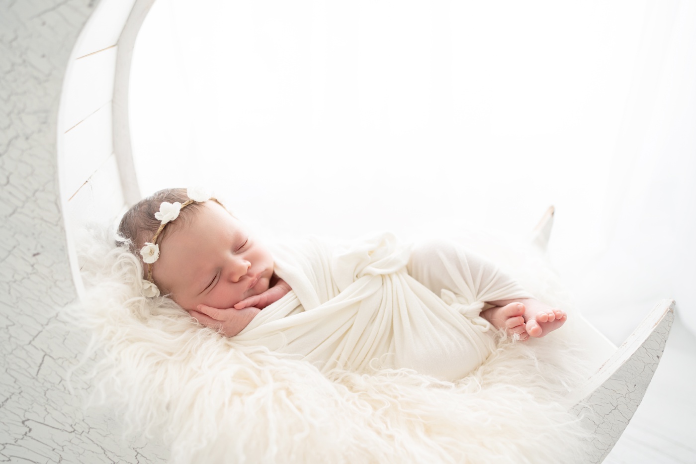  newborn baby in white moon prop in white studio