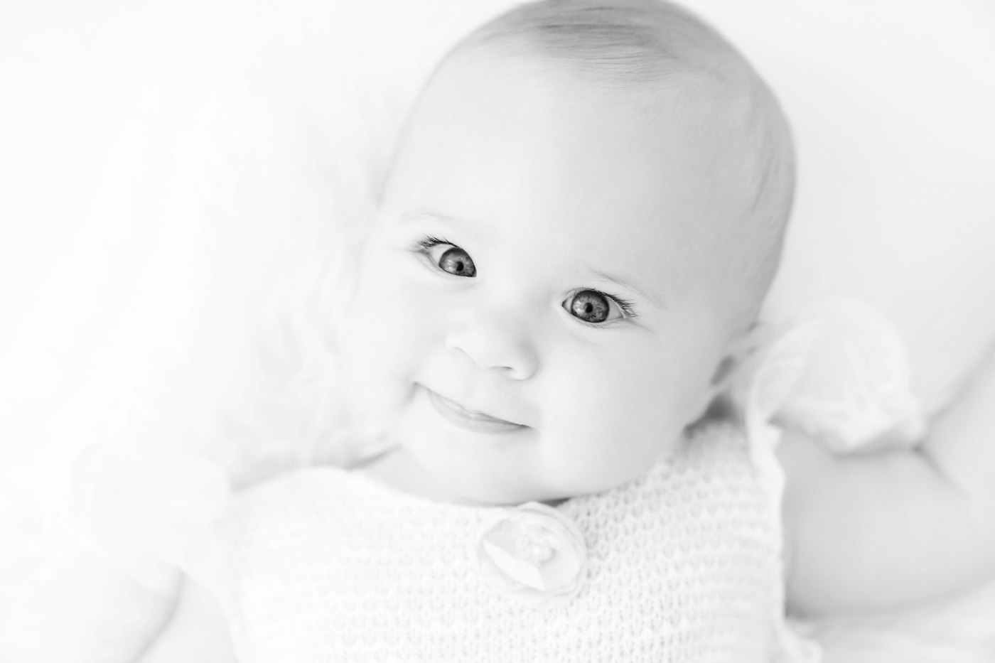 baby being photographed in a white photography studio