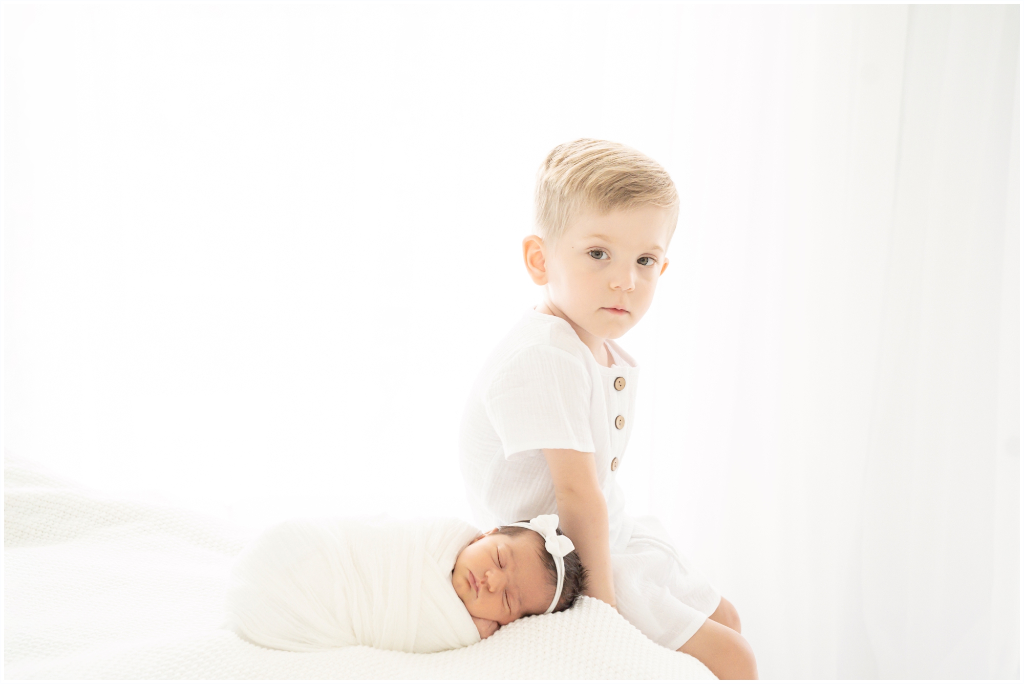Brother and new baby at their Newborn Photoshoot in Jupiter Fl studio