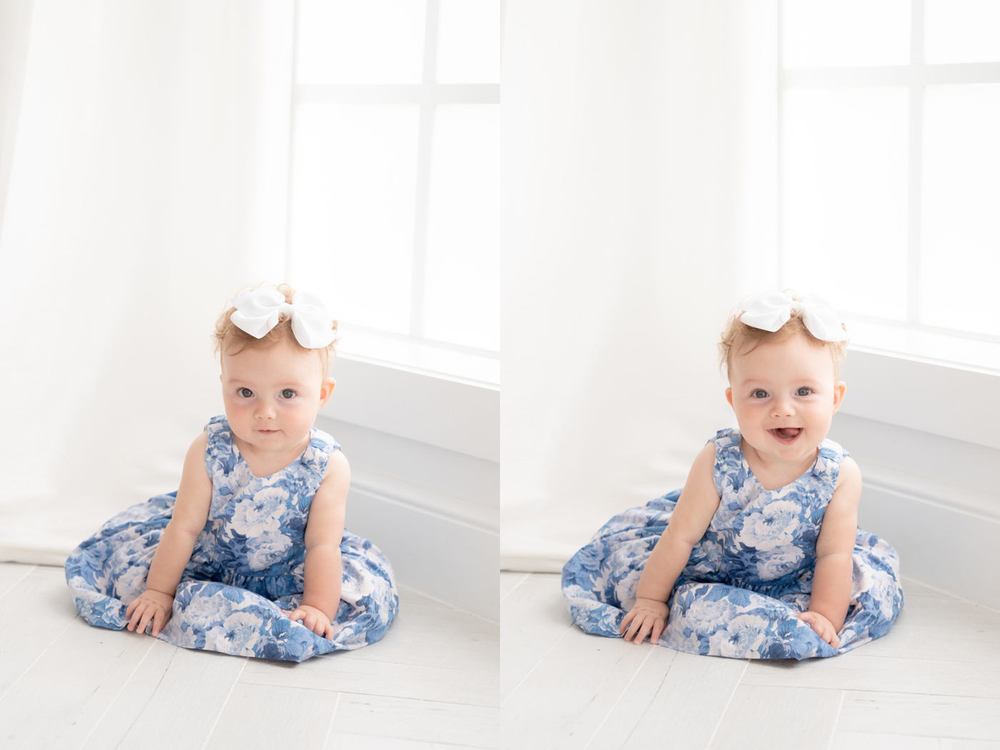 Baby girl sitting the floor of a white photography studio wearing a white and blue floral dress
